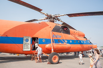 Image showing Visitors of air show explore the MI-6A helicopter