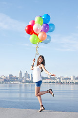 Image showing Happy young woman with colorful balloons