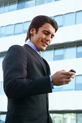 Image showing a businessman using mobile phone b