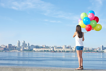 Image showing Happy young woman with colorful balloons