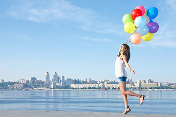 Image showing Happy young woman with colorful balloons