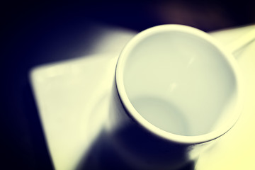 Image showing White cup on dark table