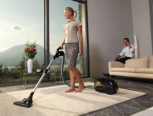 Image showing housewife with vacuum cleaner