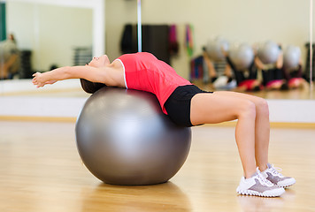 Image showing young woman doing exercise on fitness ball