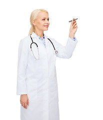 Image showing female doctor working with something imaginary