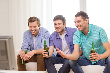 Image showing happy male friends with beer watching tv at home