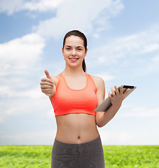 Image showing sporty woman with tablet pc computer