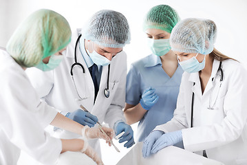 Image showing young group of doctors doing operation