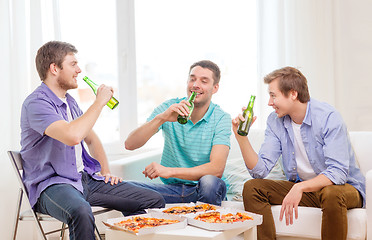 Image showing smiling friends with beer and pizza hanging out