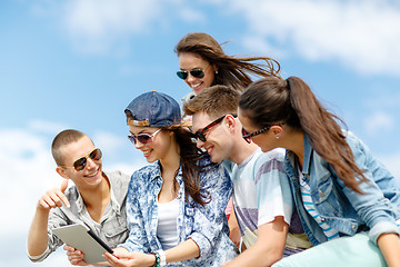 Image showing group of teenagers looking at tablet pc computer