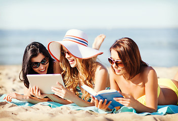 Image showing girls with tablet pc on the beach