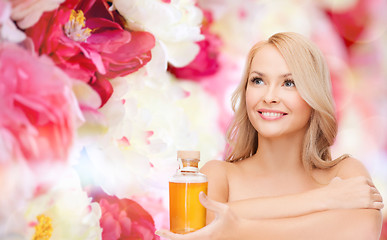 Image showing happy woman with oil bottle