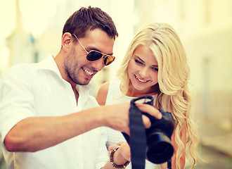 Image showing smiling couple with photo camera