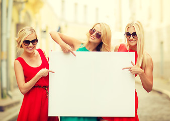 Image showing three happy blonde women with blank white board