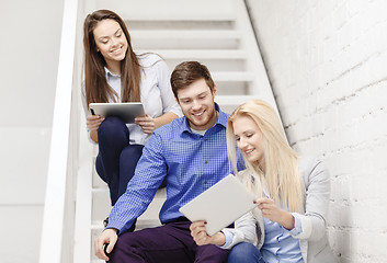 Image showing team with tablet pc computer sitting on staircase