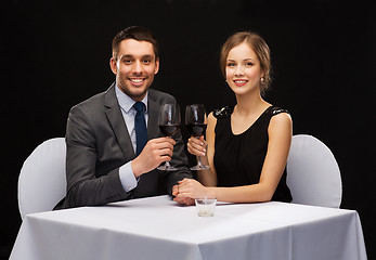 Image showing young couple with glasses of wine at restaurant