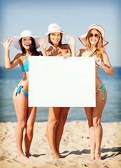 Image showing girls with blank board on the beach