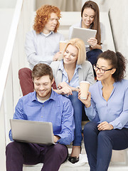 Image showing team with laptop and tablet pc on staircase