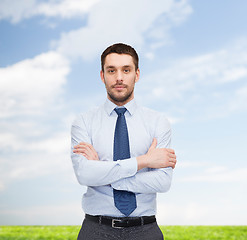 Image showing handsome businessman with crossed arms