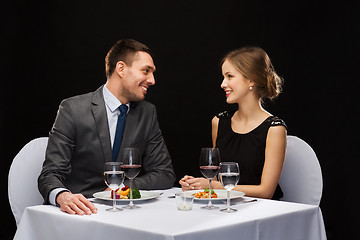 Image showing smiling couple eating main course at restaurant