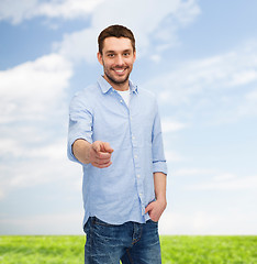 Image showing smiling man pointing finger at you