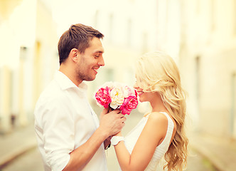 Image showing couple with flowers in the city