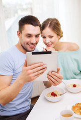 Image showing smiling couple with taking picture with tablet pc