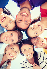 Image showing group of teenagers looking down