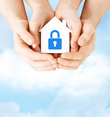 Image showing hands holding paper house with lock