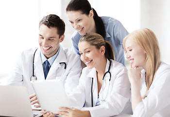 Image showing group of doctors looking at tablet pc