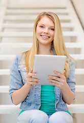 Image showing smiling female student with tablet pc computer