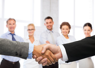 Image showing businessman and businesswoman shaking hands