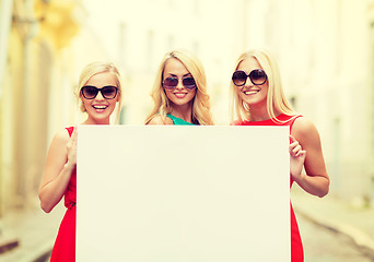 Image showing three happy blonde women with blank white board