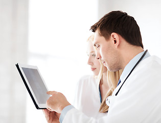 Image showing two doctors looking at x-ray on tablet pc