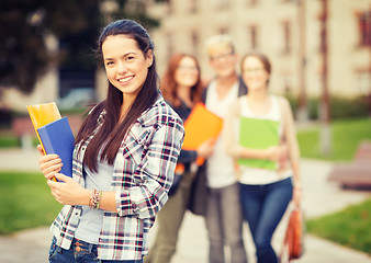 Image showing teenage girl with folders and mates on the back