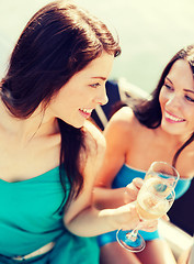 Image showing girls with champagne glasses on boat