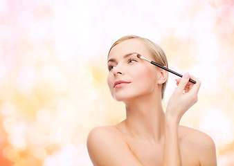 Image showing beautiful woman with makeup brush