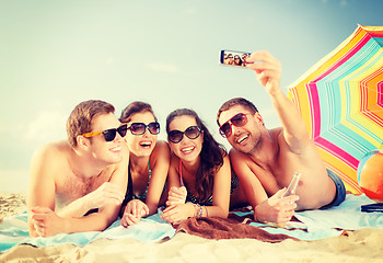 Image showing group of people taking picture with smartphone