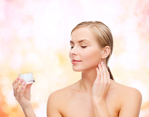 Image showing woman applying cream on her skin