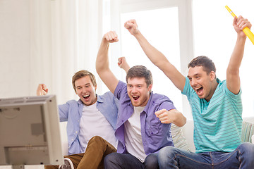 Image showing happy male friends with vuvuzela watching sports