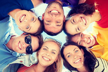 Image showing group of teenagers looking down