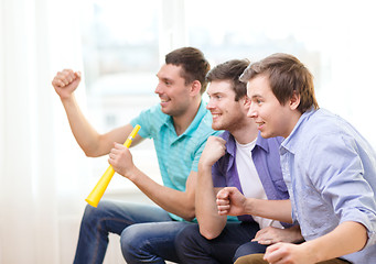 Image showing happy male friends with vuvuzela watching sports