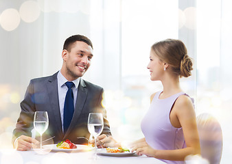 Image showing smiling couple eating main course at restaurant