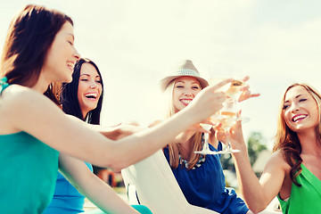 Image showing girls with champagne glasses on boat