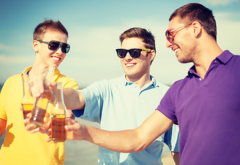 Image showing group of male friends having fun on the beach