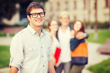 Image showing teenage boy with classmates on the back