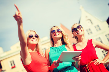 Image showing beautiful girls toursits looking into tablet pc