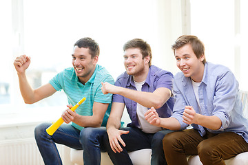 Image showing happy male friends with vuvuzela watching sports