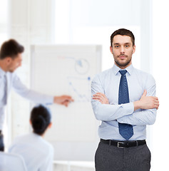 Image showing handsome businessman with crossed arms