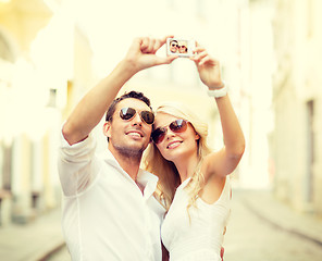 Image showing travelling couple taking photo picture with camera